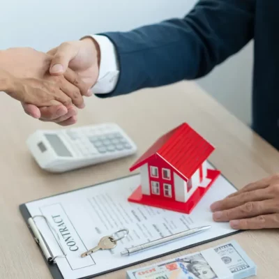 Solicitor and property buyer shaking hands over a contract of sale